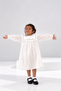 Ivory striped cotton girls dress with an embroidered scallop collar and balloon sleeves