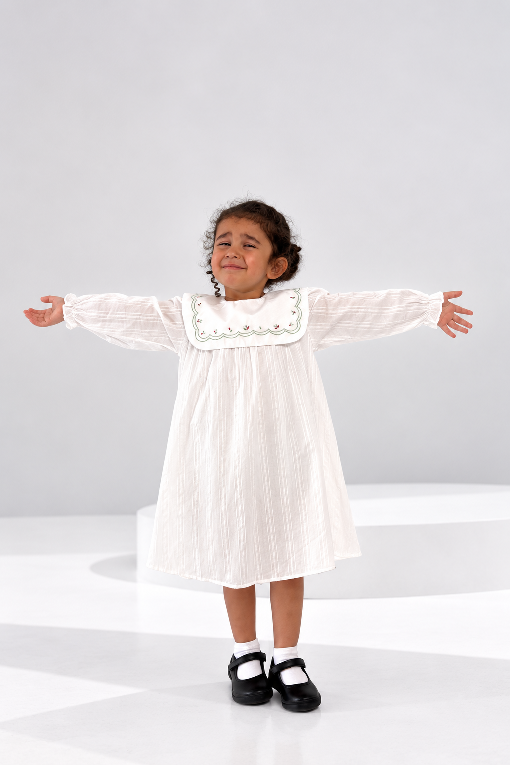 Ivory striped cotton girls dress with an embroidered scallop collar and balloon sleeves