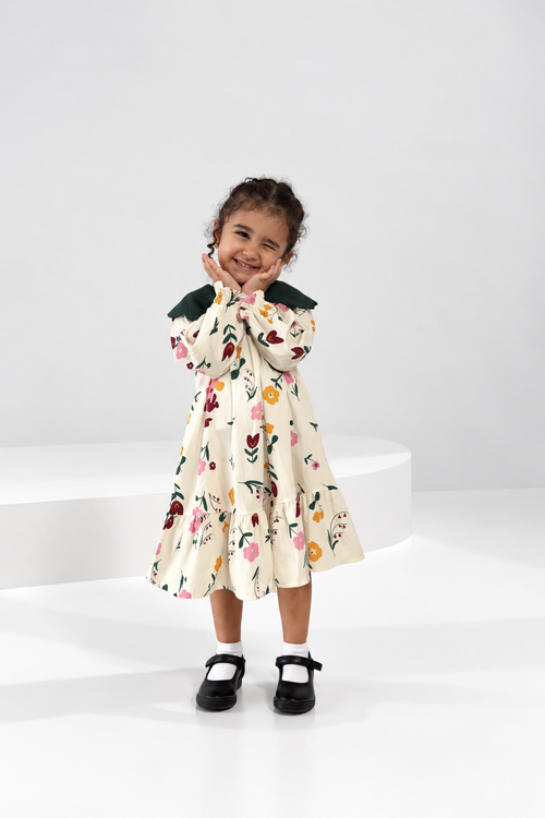Cream floral tiered girls dress with a green scalloped collar